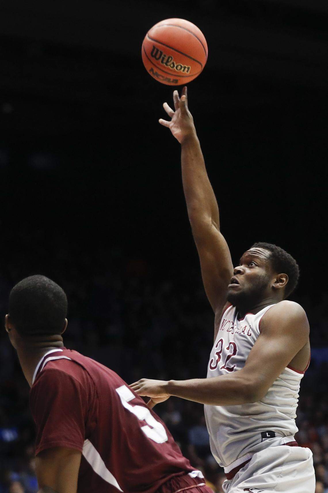 North Carolina Central's Raasean Davis (32) shoots as Texas Southern's Trayvon Reed watches during the second half.