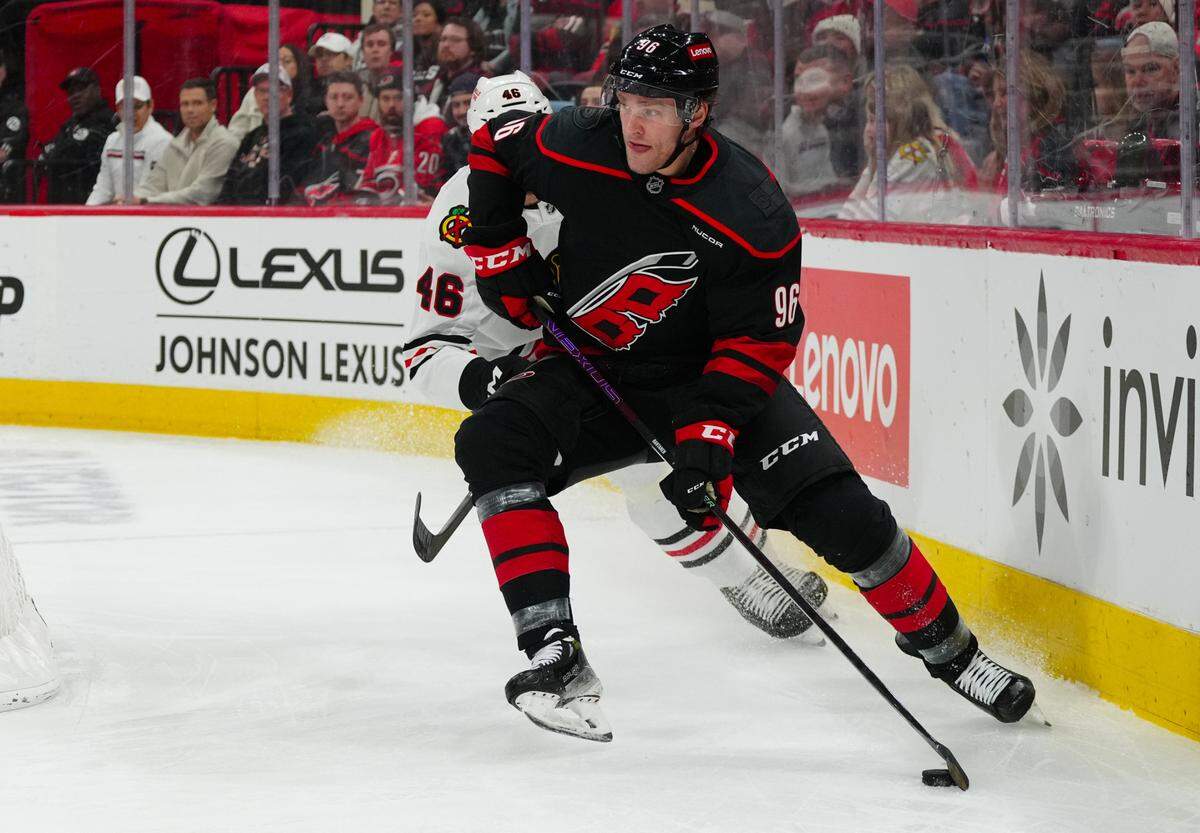 Carolina Hurricanes right wing Mikko Rantanen (96) skates with the puck past Chicago Blackhawks defenseman Louis Crevier (46) during the first period at Lenovo Center.