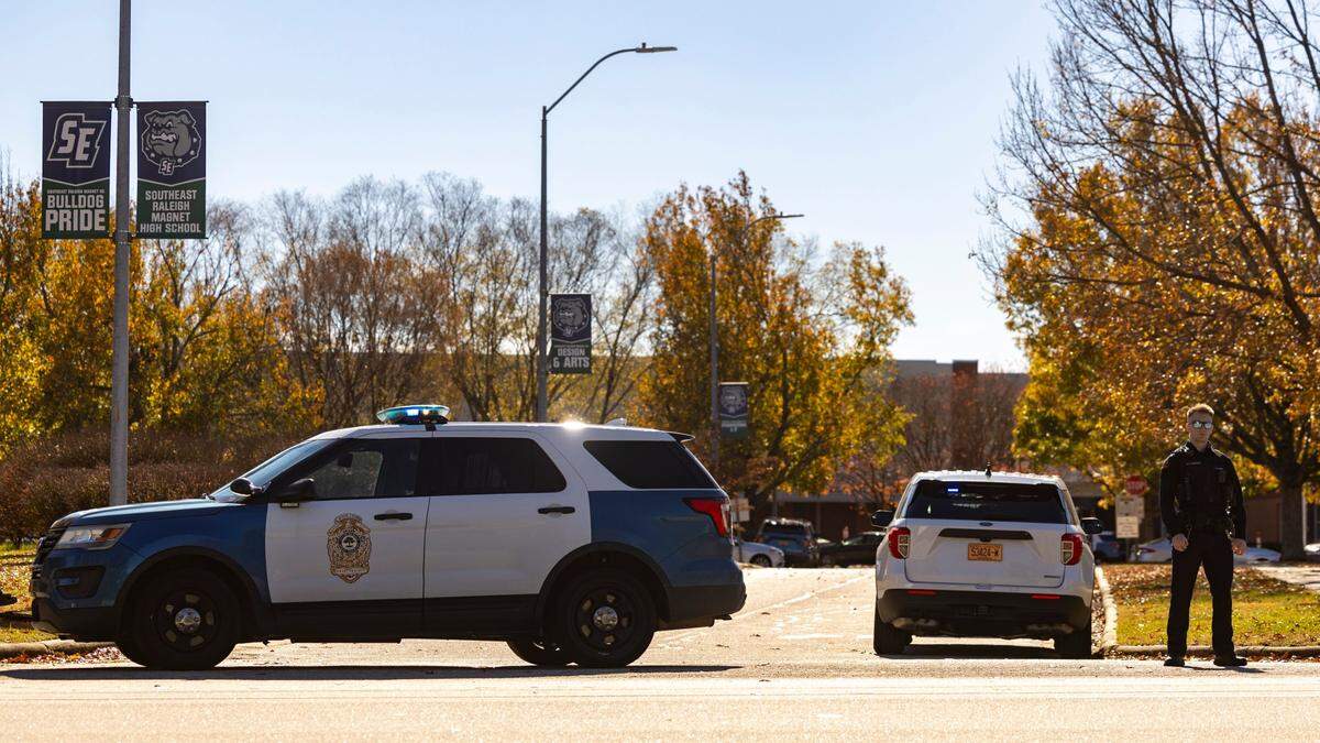 Police block an entrance at Southeast Raleigh High School during a Code Red lockdown Monday, Nov. 27, 2023. The school is on lockdown after a person was stabbed on campus.