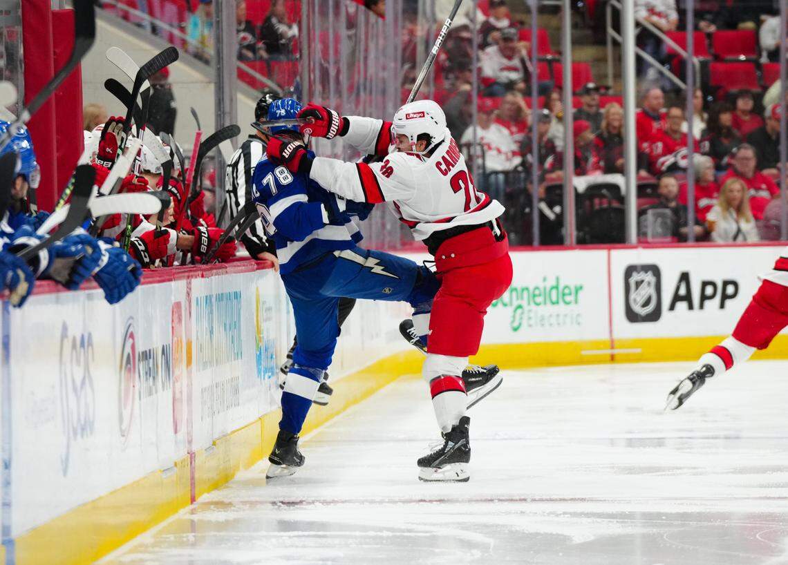 Oct 4, 2024; Raleigh, North Carolina, USA; Carolina Hurricanes left wing William Carrier (28) checks Tampa Bay Lightning defenseman Emil Lilleberg (78) during the first period at PNC Arena. Mandatory Credit: James Guillory-Imagn Images