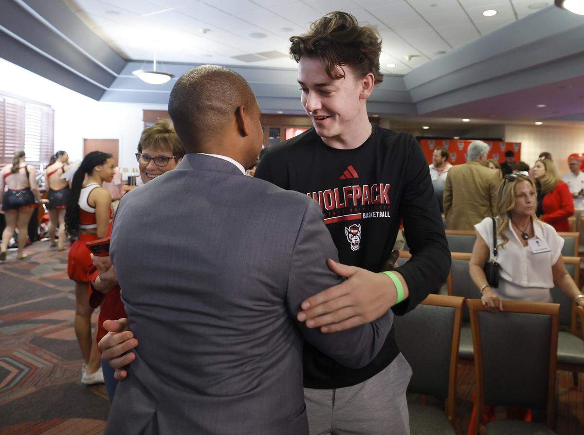 New N.C. State head men’s basketball coach Justin Gainey talks with Cole Cloer after a press conference where Gainey was officially introduced as coach Wednesday, April 1, 2026. Cloer, a class of 2026 prospect, signed with the Wolfpack under Will Wade.