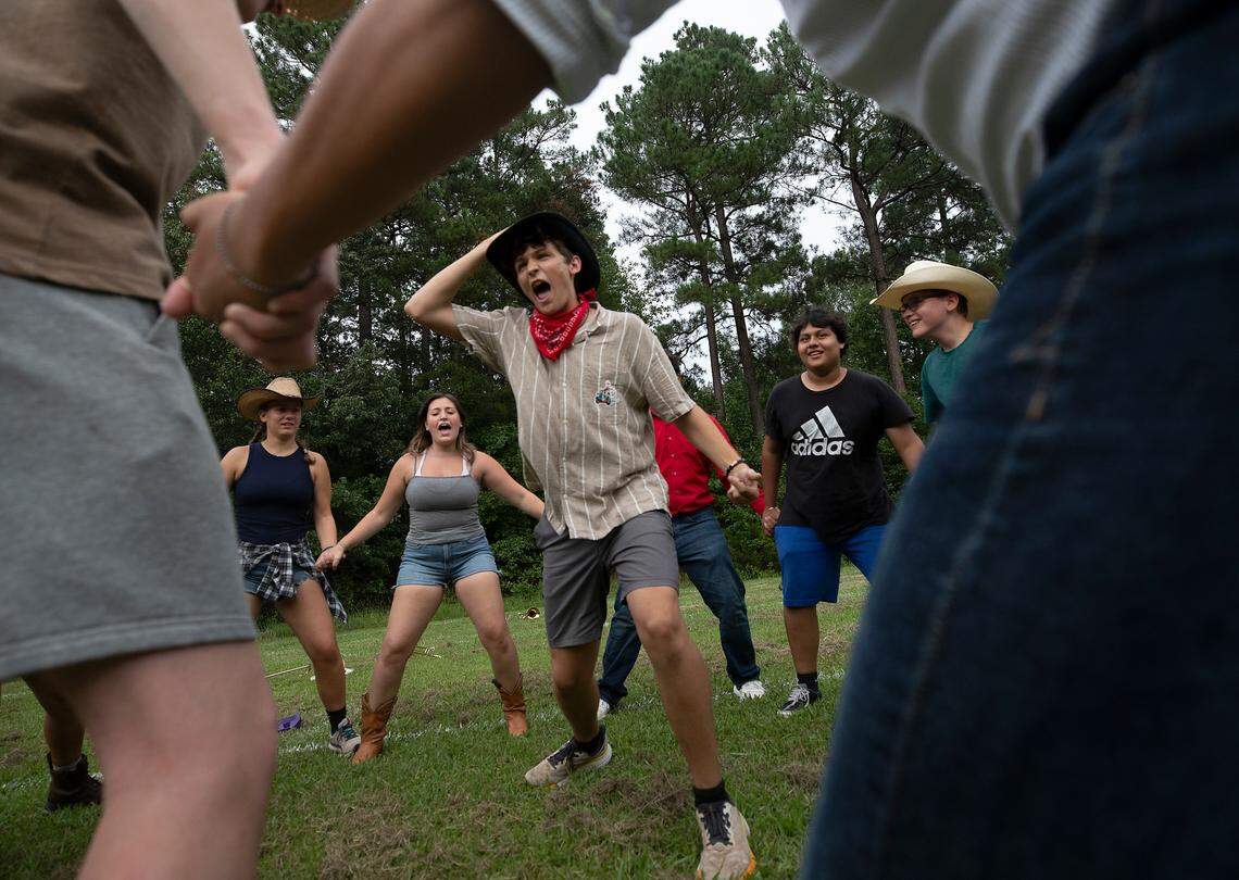 Senior tuba and guitar player Andrew Schreiber leads his peers in a chant prior to a performance on the final day of marching band camp at Jordan High School on Friday, August 2, 2024, in Durham, N.C.