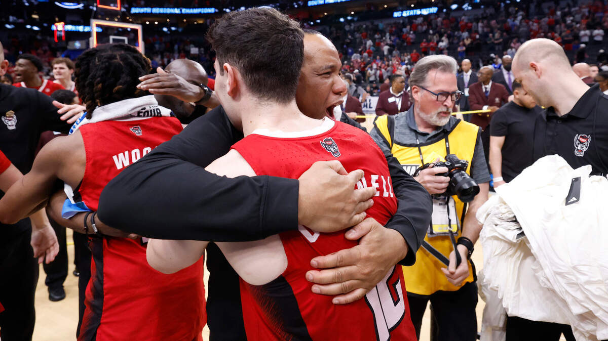 N.C. State head coach Kevin Keatts hugs Michael O’Connell (12) after the Wolfpack’s 76-64 victory over Duke in their NCAA Tournament Elite Eight matchup at the American Airlines Center in Dallas, Texas, Sunday, March 31, 2024.