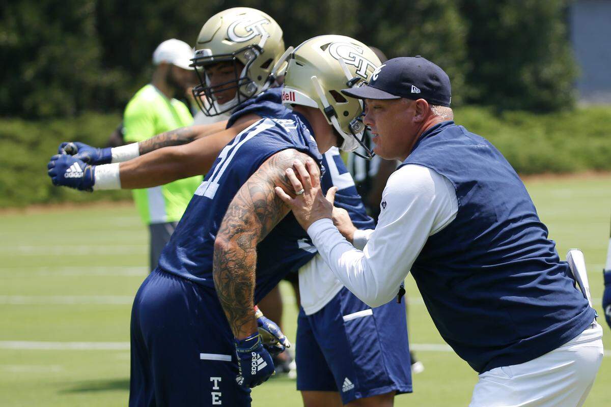Georgia Tech head coach Geoff Collins works with his players during the team’s first preseason NCAA college football practice Wednesday, July 31, 2019, in Atlanta.