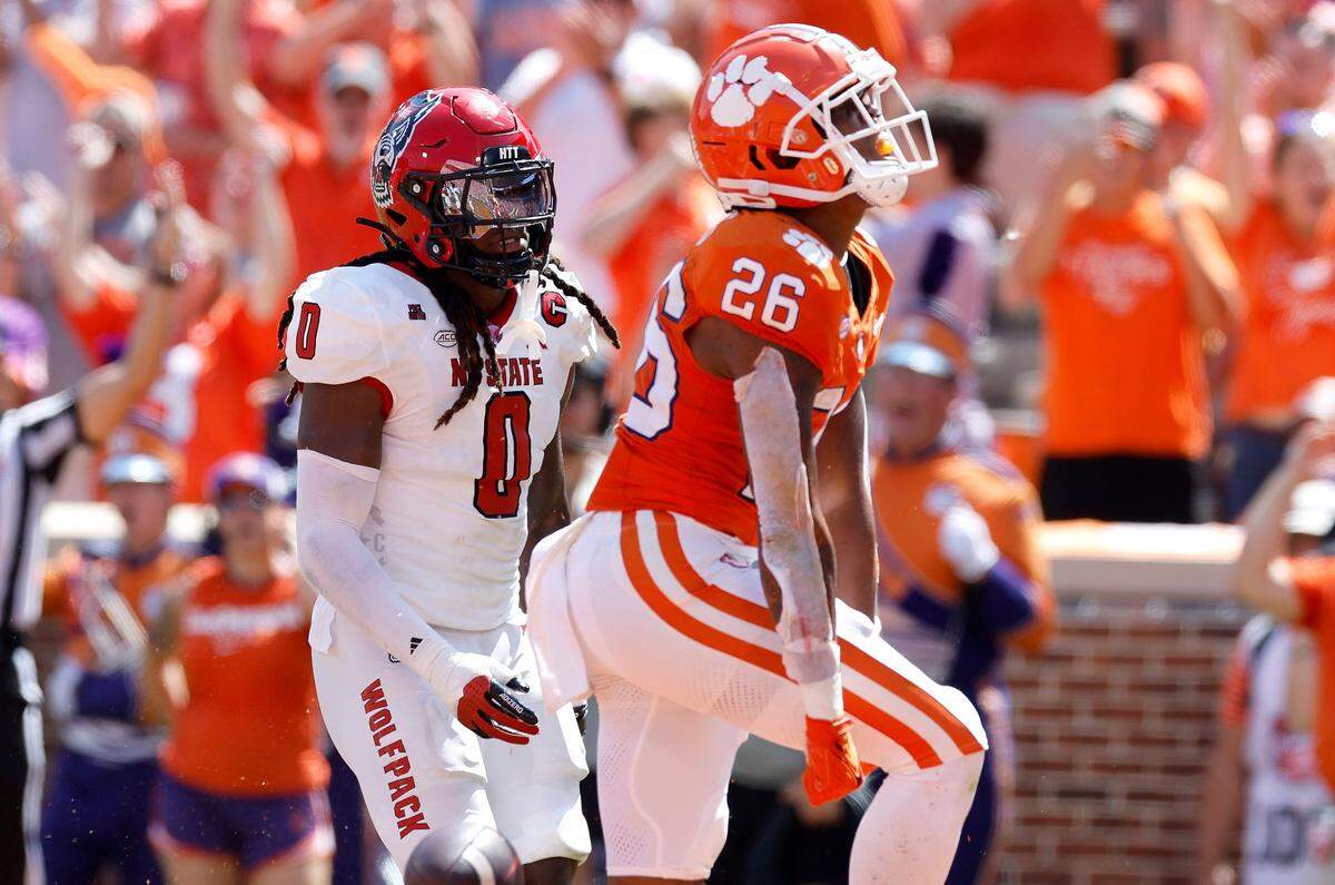 Clemson running back Jay Haynes (26) celebrates scoring on a 19-yard touchdown run as N.C. State linebacker Sean Brown (0) looks on during the first half of N.C. State’s game against Clemson at Memorial Stadium in Clemson, S.C., Saturday, Sept. 21, 2024.