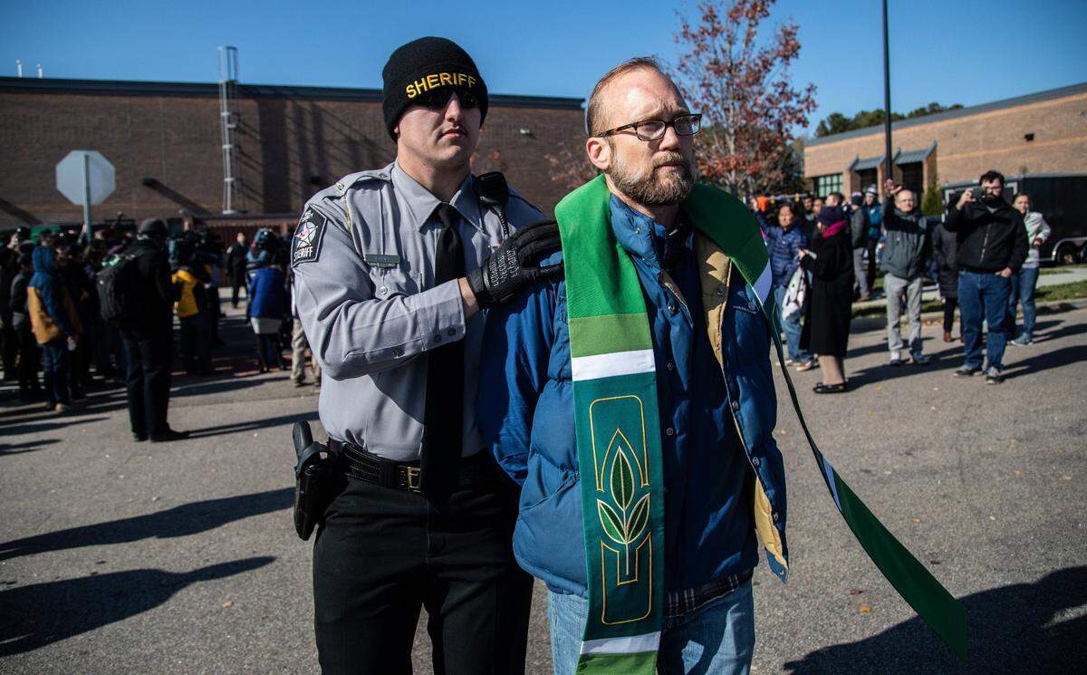 Pastor Cleve May of CityWell United Methodist Church is arrested after Samuel Oliver-Bruno, 47, an undocumented man was arrested Friday by immigration officers in Morrisville after he left the CityWell church where he has been living for 11 months. Churches are one of the few places where U.S. Immigration and Customs Enforcement do not make arrests.