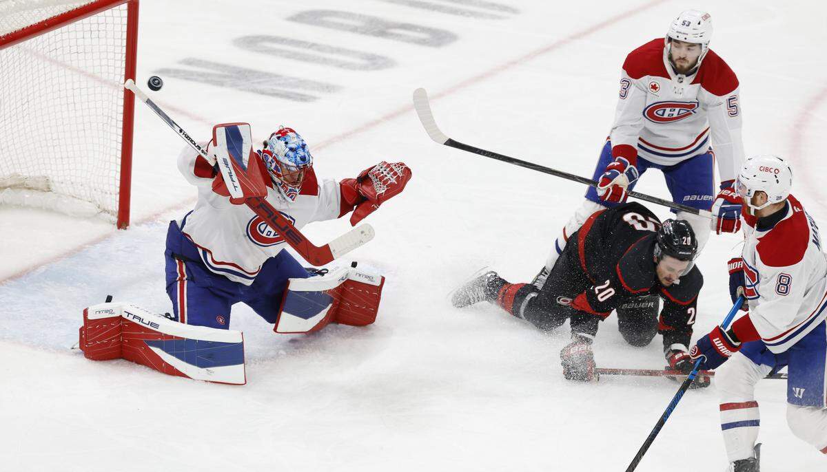The puck goes wide as Montréal's Jakub Dobes (75) defends in the third period of the Hurricanes’ game against the Canadiens in game two of the Eastern Conference Finals at the Lenovo Center in Raleigh, N.C., Saturday, May 23, 2026.