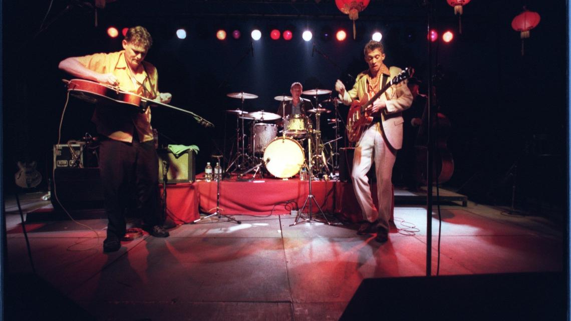 From left, Tom Maxwell, Chris Phillips and Jimbo Mathus perform with Squirrel Nut Zippers at a 1997 free concert for the town of Carrboro. More than 5,000 fans attended.