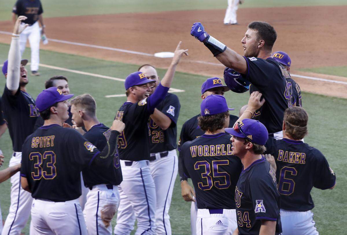 ECU’s Spencer Brickhouse (42) is lifted up after scoring on a home run in the third inning during East Carolina’s elimination game with Campbell in the Greenville Regional at Clark-LeClair Stadium in Greenville, N.C., Monday, June 3, 2019.