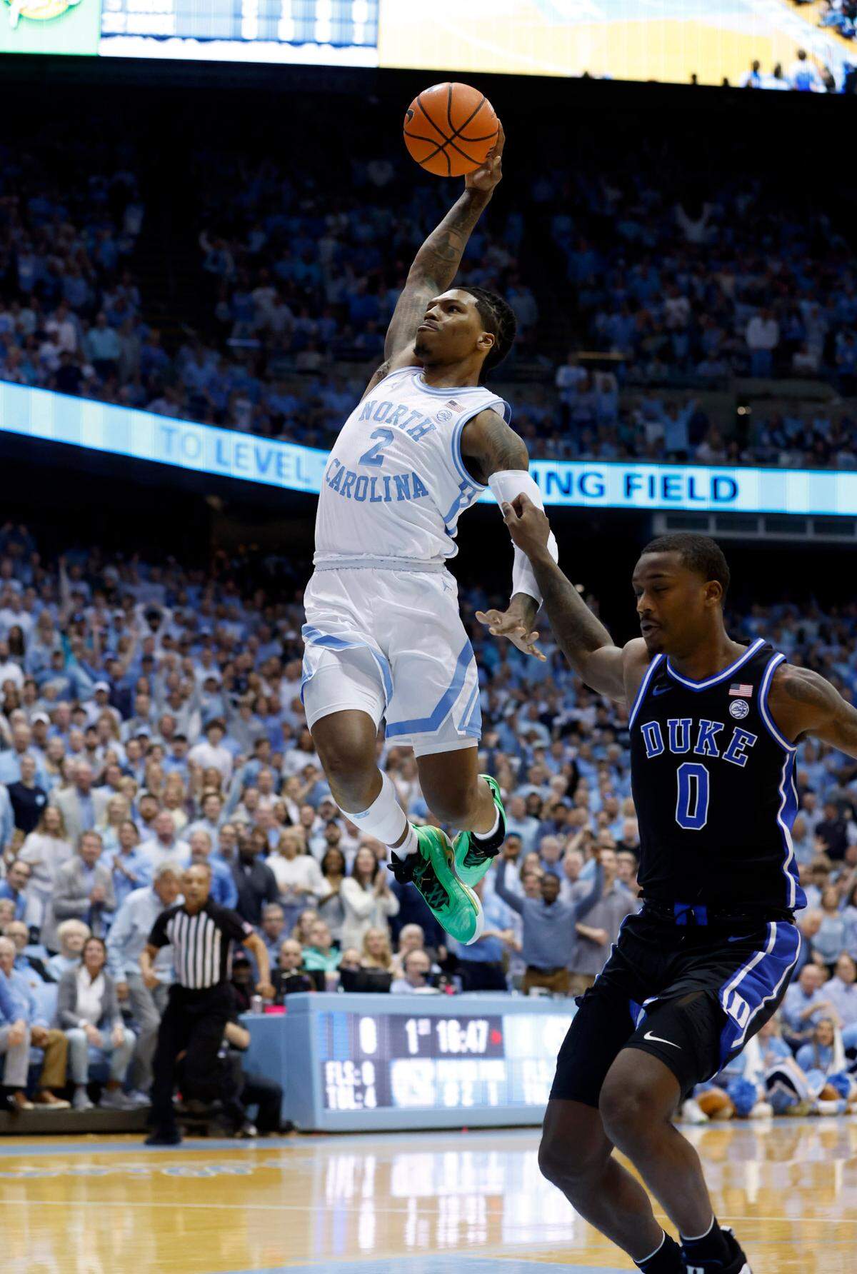 North Carolina’s Caleb Love (2) heads to the basket to try to dunk the ball while driving past Duke’s Dariq Whitehead (0) during the first half of UNC’s game against Duke at the Smith Center in Chapel Hill, N.C., Saturday, March 4, 2023.