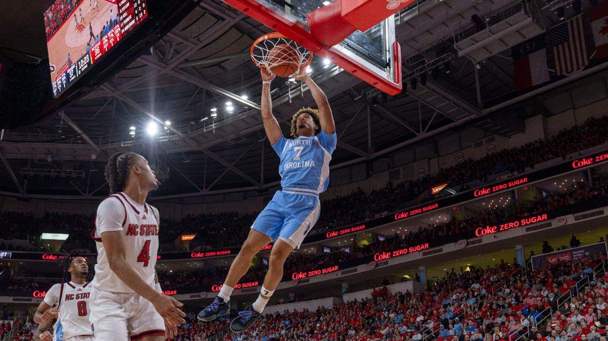 North Carolina guard Seth Trimble (7) breaks to the basket for a dunk over N.C. State’s Breon Pass (4) in the second half on Saturday, January 11, 2025 at Lenovo Center in Raleigh, N.C.