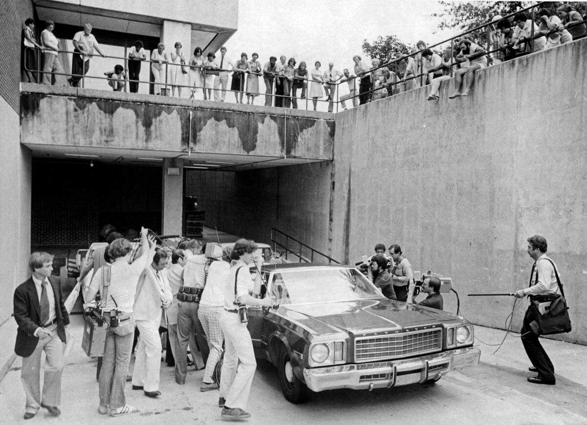 Photographers surround a US Marshall’s car carrying Dr. Jeffrey MacDonald after he was convicted of murder in Raleigh, NC in 1979.
