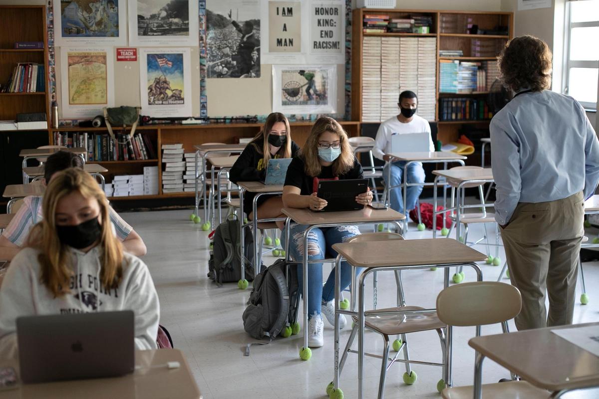 Student teacher Jim Bitzes teaches American History on Thursday, April 8, 2021 at Broughton High School in Raleigh, N.C. More than 1,200 students returned for in-person classes on Thursday at Broughton on the first day of Wake County Schools’ Plan A implementation.