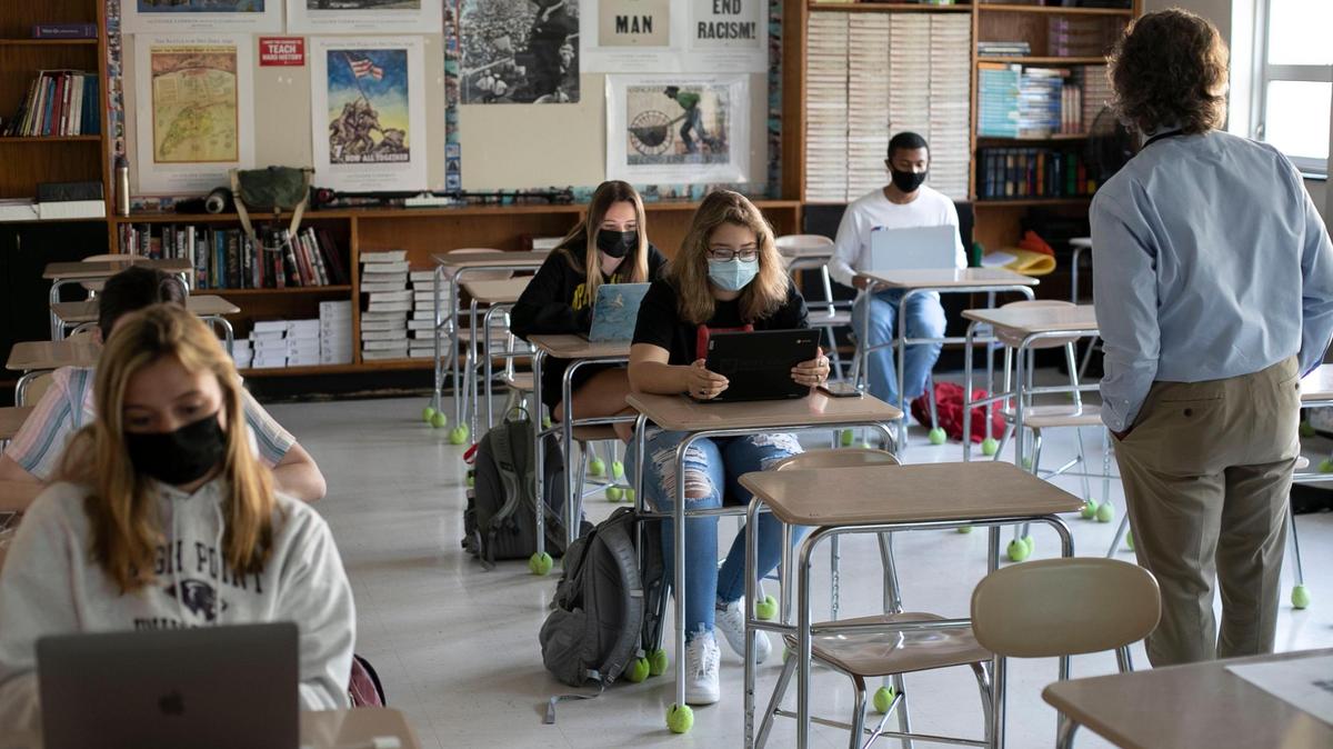 Student teacher Jim Bitzes teaches American History on Thursday, April 8, 2021 at Broughton High School in Raleigh, N.C. More than 1,200 students returned for in-person classes on Thursday at Broughton on the first day of Wake County Schools’ Plan A implementation.