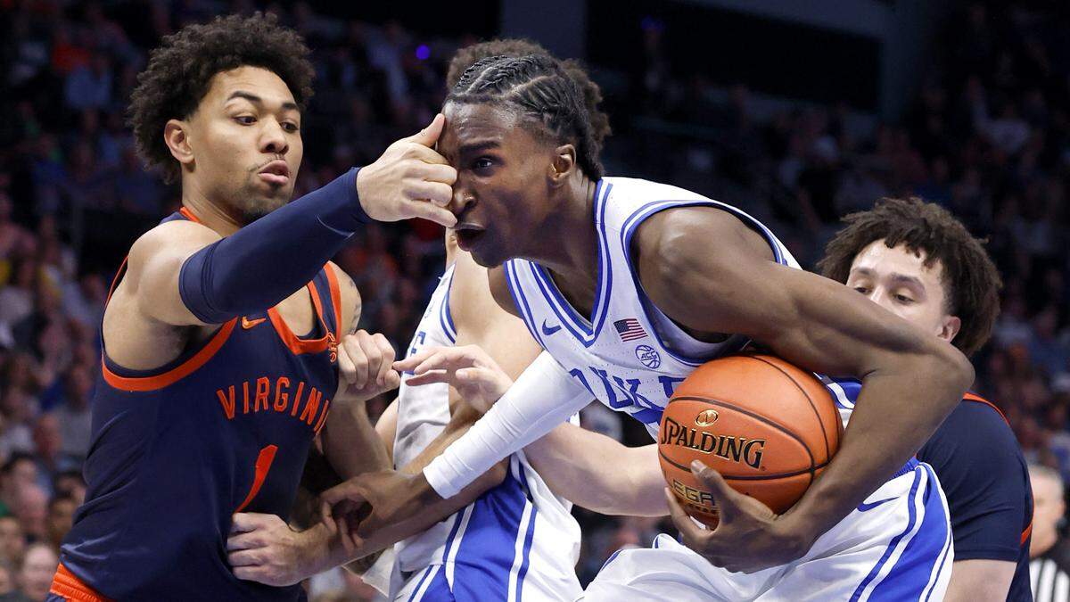 Duke’s Dame Sarr (7) is fouled by Virginia's Malik Thomas (1) during the first half of Duke’s game against Virginia in the finals of the 2026 ACC Men’s Basketball Tournament at the Spectrum Center in Charlotte, N.C., Saturday, March 14, 2026.
