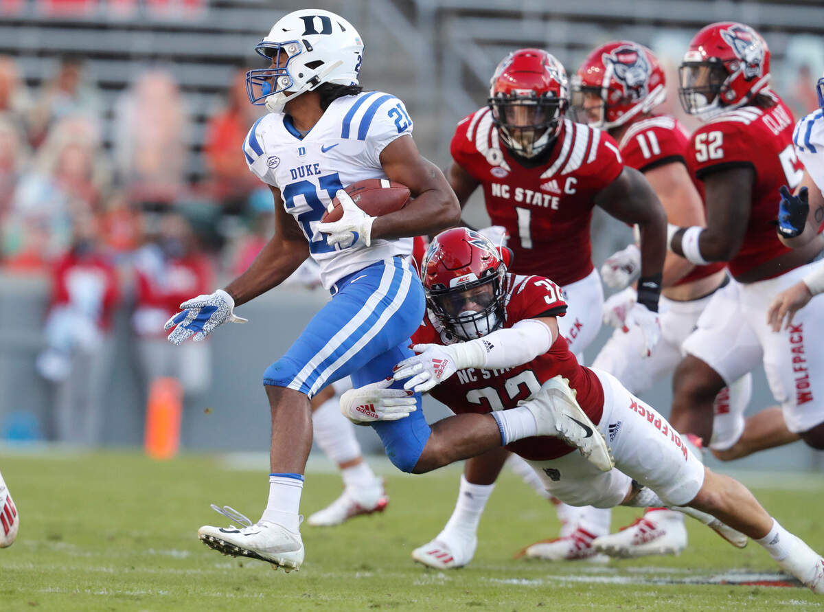 N.C. State linebacker Drake Thomas (32) tackles Duke running back Mataeo Durant (21) for a loss during the first half of N.C. State’s game against Duke at Carter-Finley Stadium in Raleigh, N.C., Saturday, Oct. 17, 2020.