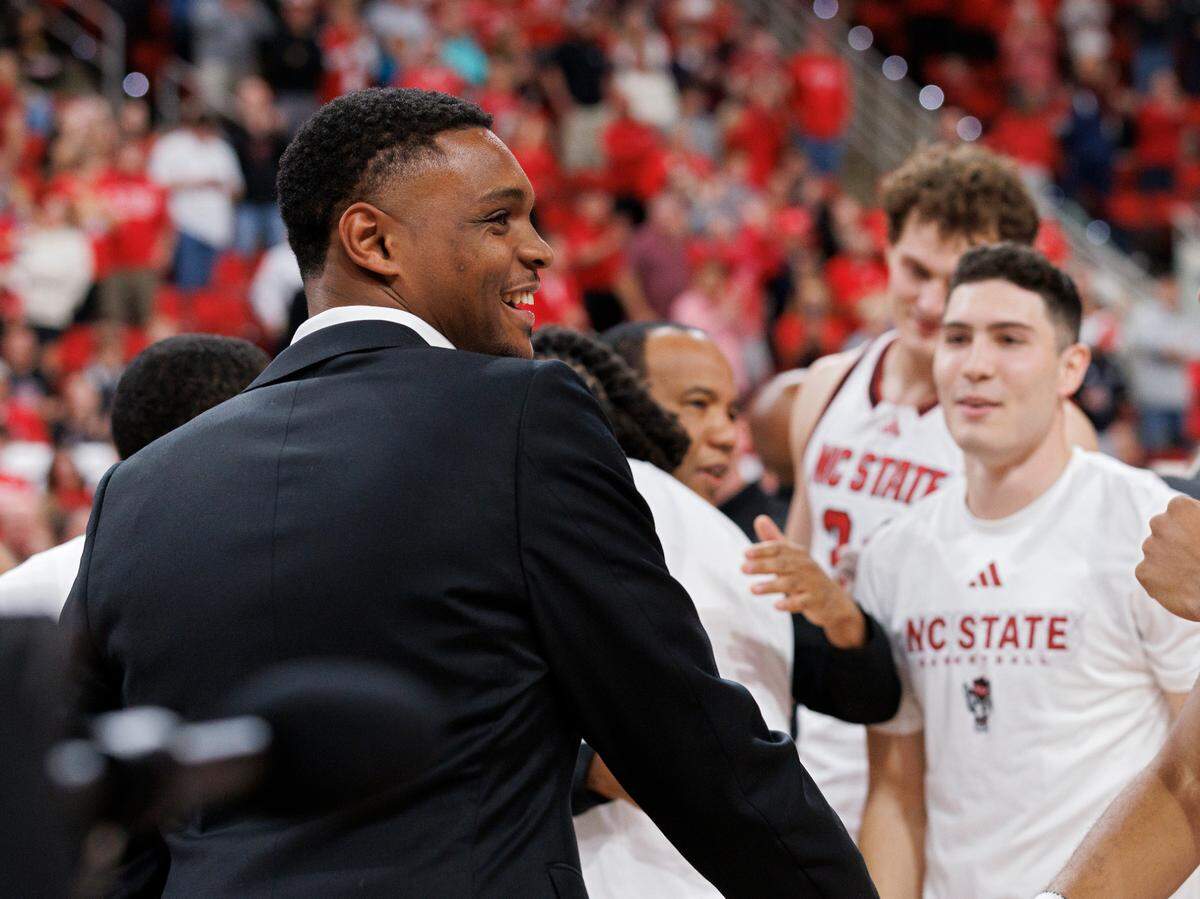 Former N.C. State guard Casey Morsell smiles as he stands with his former teammates during a banner ceremony to commemorate the Wolfpack’s 2024 NCAA Tournament Final Four appearance and ACC Tournament championship on Monday, Nov. 4, 2024, at Lenovo Center in Raleigh, N.C.