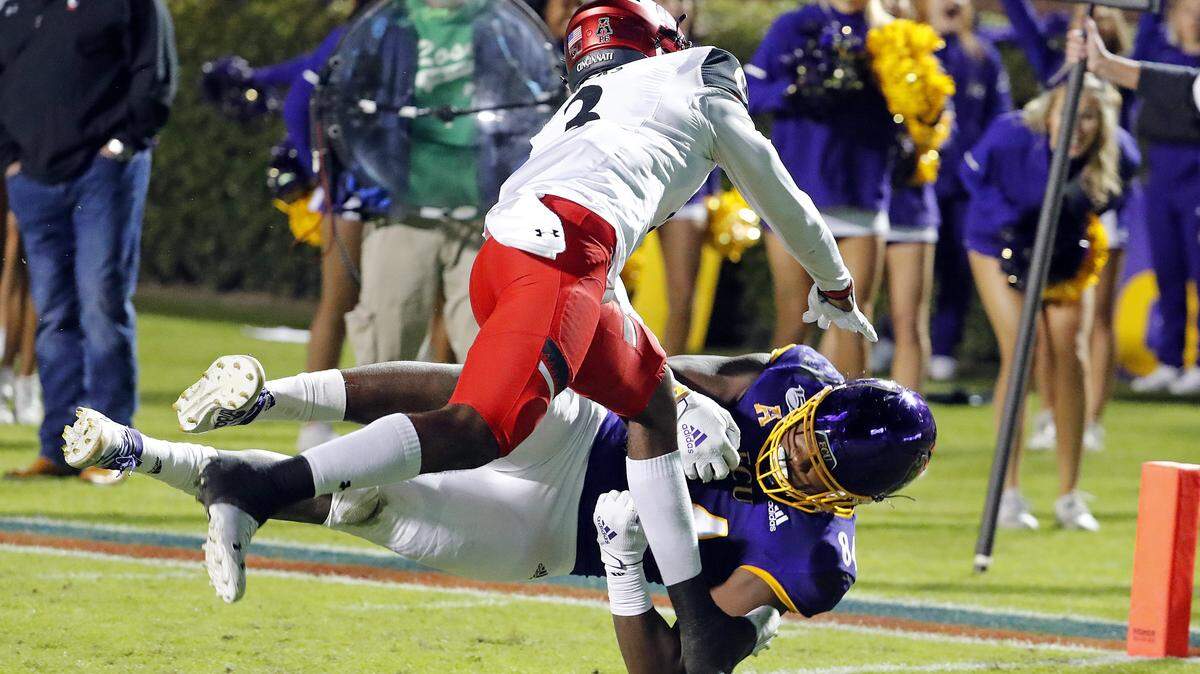 East Carolina’s Zech Byrd (84) goes into the end zone while covered by Cincinnati’s Ja’von Hicks (3) during the first half of an NCAA college football game in Greenville, N.C., Saturday, Nov. 2, 2019. (AP Photo/Karl B DeBlaker)