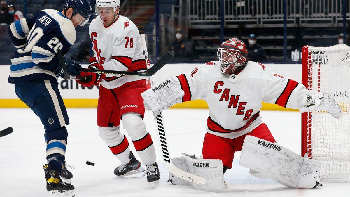Carolina Hurricanes’ Alex Nedeljkovic, right, makes a save as teammate Brady Skjei, center, and Columbus Blue Jackets’ Riley Nash look for the puck during the second period of an NHL hockey game Monday, March 22, 2021, in Columbus, Ohio. (AP Photo/Jay LaPrete)