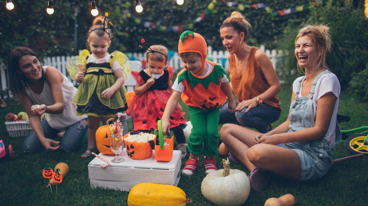 A family enjoying some candy in their backyard after Halloween night.