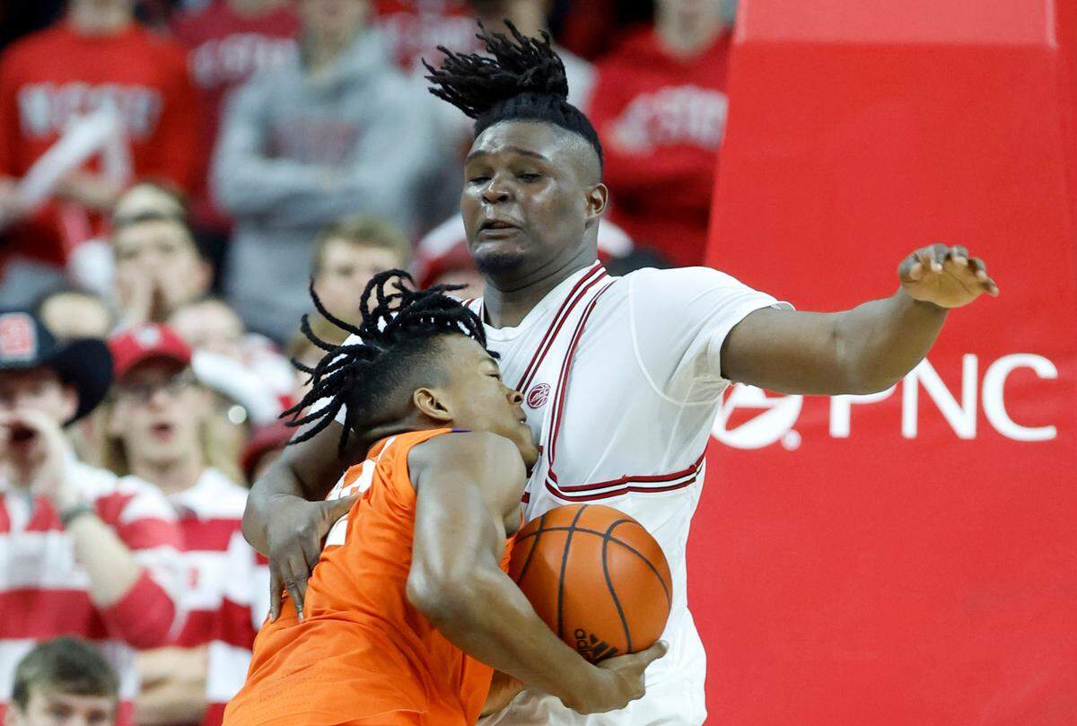 Clemson’s RJ Godfrey (22) tries to get around N.C. State’s D.J. Burns Jr. (30) during the second half of Clemson’s 96-71 victory over N.C. State’s game at PNC Arena in Raleigh, N.C., Saturday, Feb. 25, 2023.