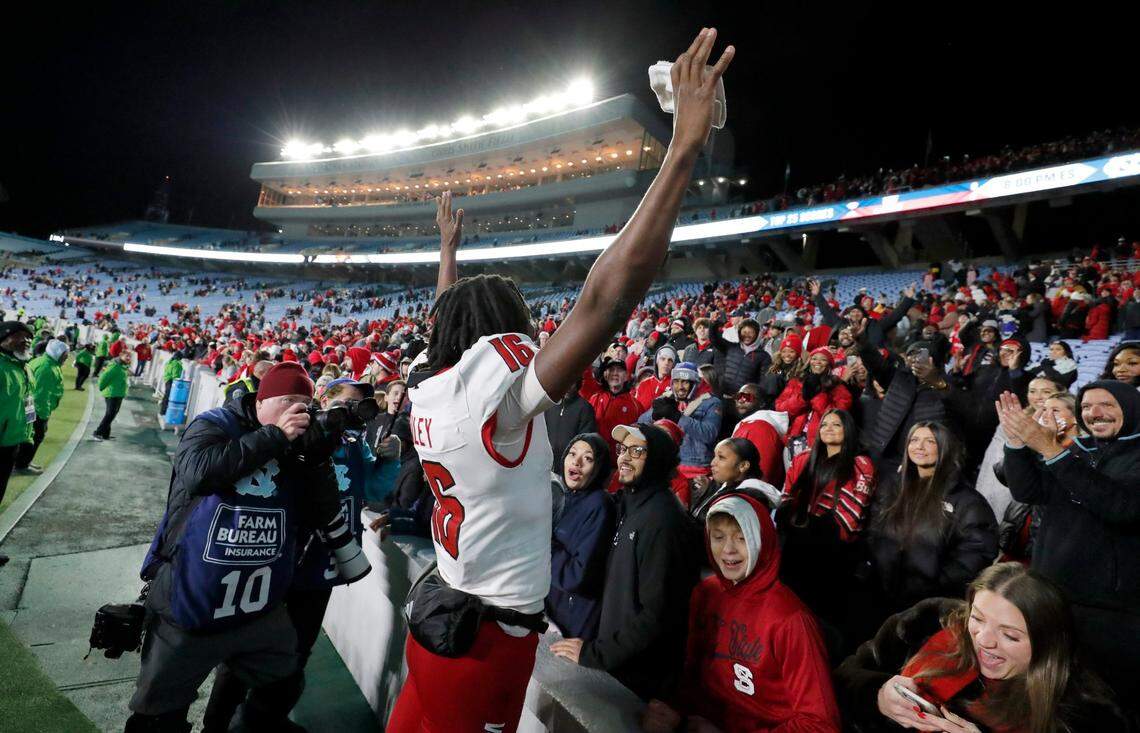 N.C. State quarterback CJ Bailey (16) celebrates the Wolfpack’s 35-30 victory over UNC at Kenan Stadium in Chapel Hill, N.C., Saturday, Nov. 30, 2024.