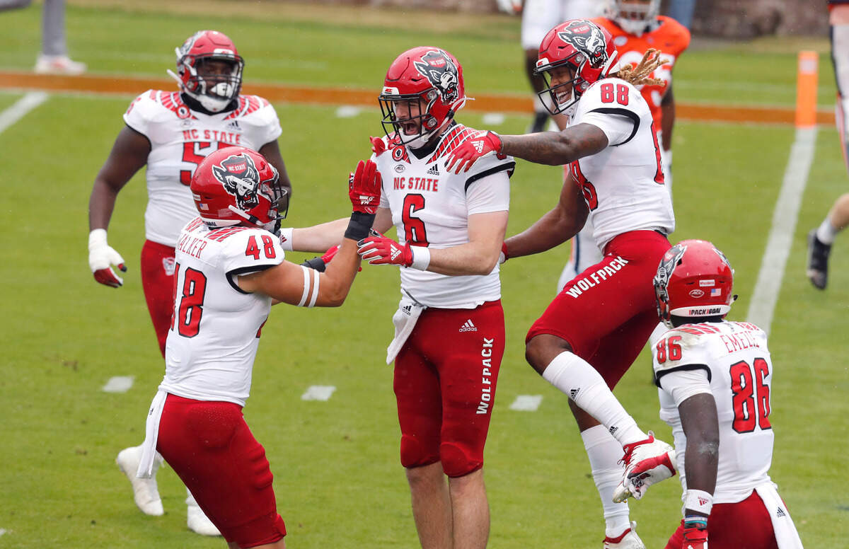 N.C. State tight end Cary Angeline (6) celebrates with Kameron Walker (48) and Devin Carter (88) after scoring on a 32-yard touchdown reception during the first half of N.C. State’s game against Virginia at Scott Stadium in Charlottesville, Va., Saturday, Oct. 10, 2020.