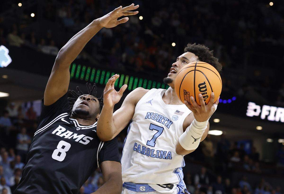 North Carolina's Seth Trimble (7) heads to the basket as VCU’s Michael Belle (8) defends during the first half of UNC’s game against VCU in the first round of the NCAA Men’s Basketball Tournament at  Bon Secours Wellness Arena in Greenville, S.C., Thursday, March 19, 2026.