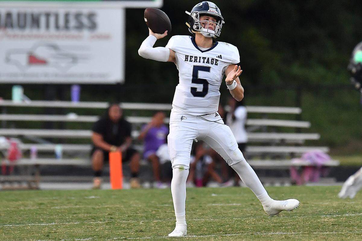 Heritage quarterback Cole Perry (5) passes the ball downfield against Leesville Road during the first half.  The Leesville Road Pride and the Heritage Huskies met in a  football game in Raleigh, N.C. on September 5, 2025.