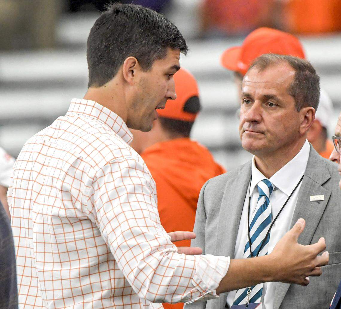 Clemson Tigers athletic director Graham Neff, left, and ACC Commissioner Jim Phillips talk before the Tigers’ game with Syracuse Orange at JMA Wireless Dome in Sept. 2023.
