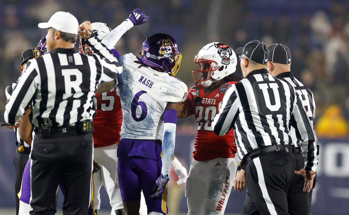 East Carolina defensive back Dontavius Nash celebrates after N.C. State running back Hollywood Smothers (20) was stopped on fourth down during the first half of N.C. State’s game against ECU in the Military Bowl at Navy-Marine Corps Memorial Stadium in Annapolis, Md., Saturday, Dec. 28, 2024.