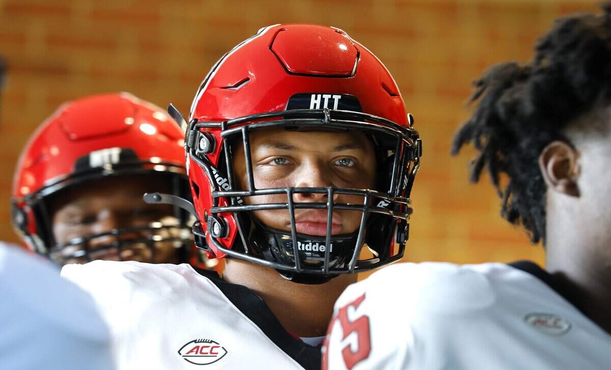 N.C. State defensive end Travali Price (13) waits to head onto the field to warmup before N.C. State’s game against Wake Forest at Allegacy Stadium in Winston-Salem, N.C., Thursday, Sept. 11, 2025.