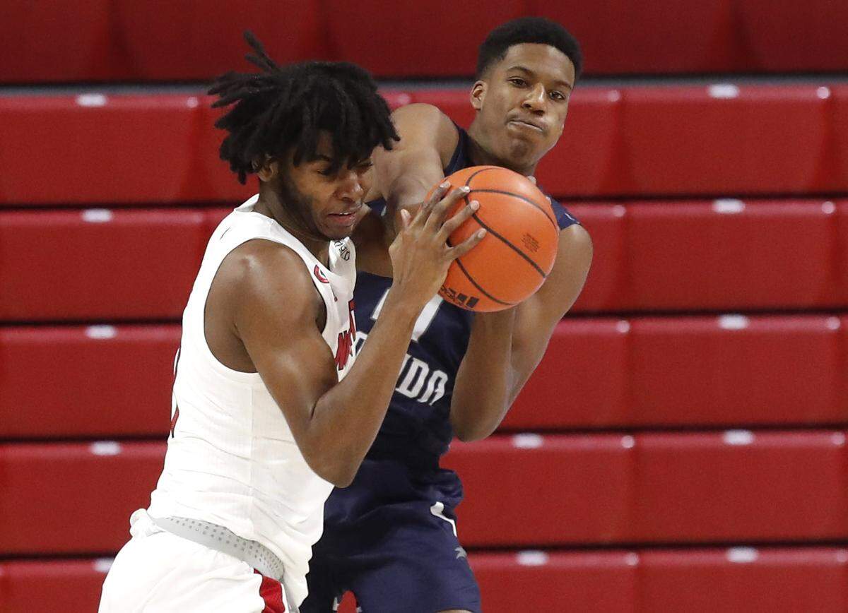 N.C. State’s Jaylon Gibson (11) fights with North Florida’s Jonathan Aybar (21) for the rebound during the second half of N.C. State’s 86-51 victory over North Florida in the Mako Medical Wolfpack Invitational at Reynolds Coliseum in Raleigh, N.C., Friday, Nov. 27, 2020.