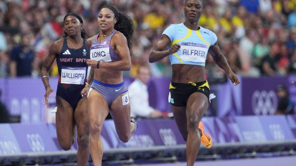 Aug 5, 2024; Saint-Denis, FRANCE; Julien Alfred (LCA) races McKenzie Long (USA) and Bianca Williams (GBR) in the women’s 200m semifinals during the Paris 2024 Olympic Summer Games at Stade de France.