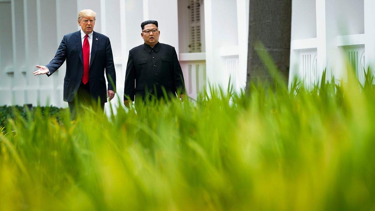 President Donald Trump and Kim Jong Un of North Korea take a walk after their lunch on Sentosa Island in Singapore, June 12, 2018.