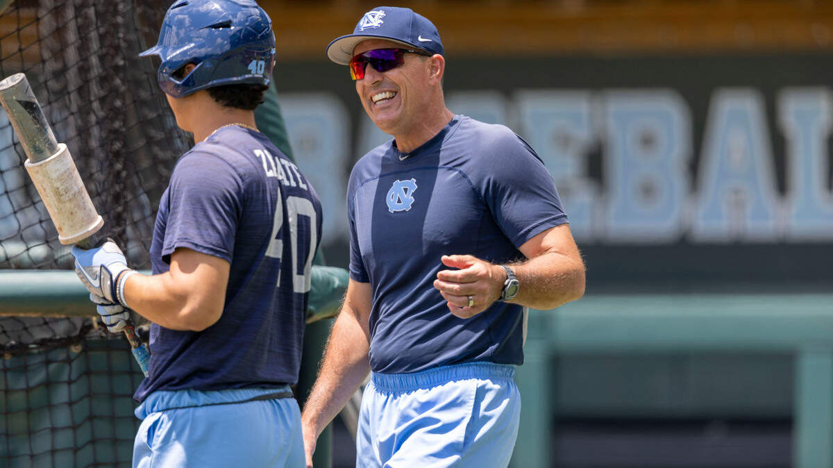 North Carolina coach Scott Forbes talks with Angel Zarate (40) during batting practice on Friday, June 10, 2022 as the Tar Heels prepare for their Super Regional series against Arkansas at Boshamer Stadium in Chapel Hill, N.C.