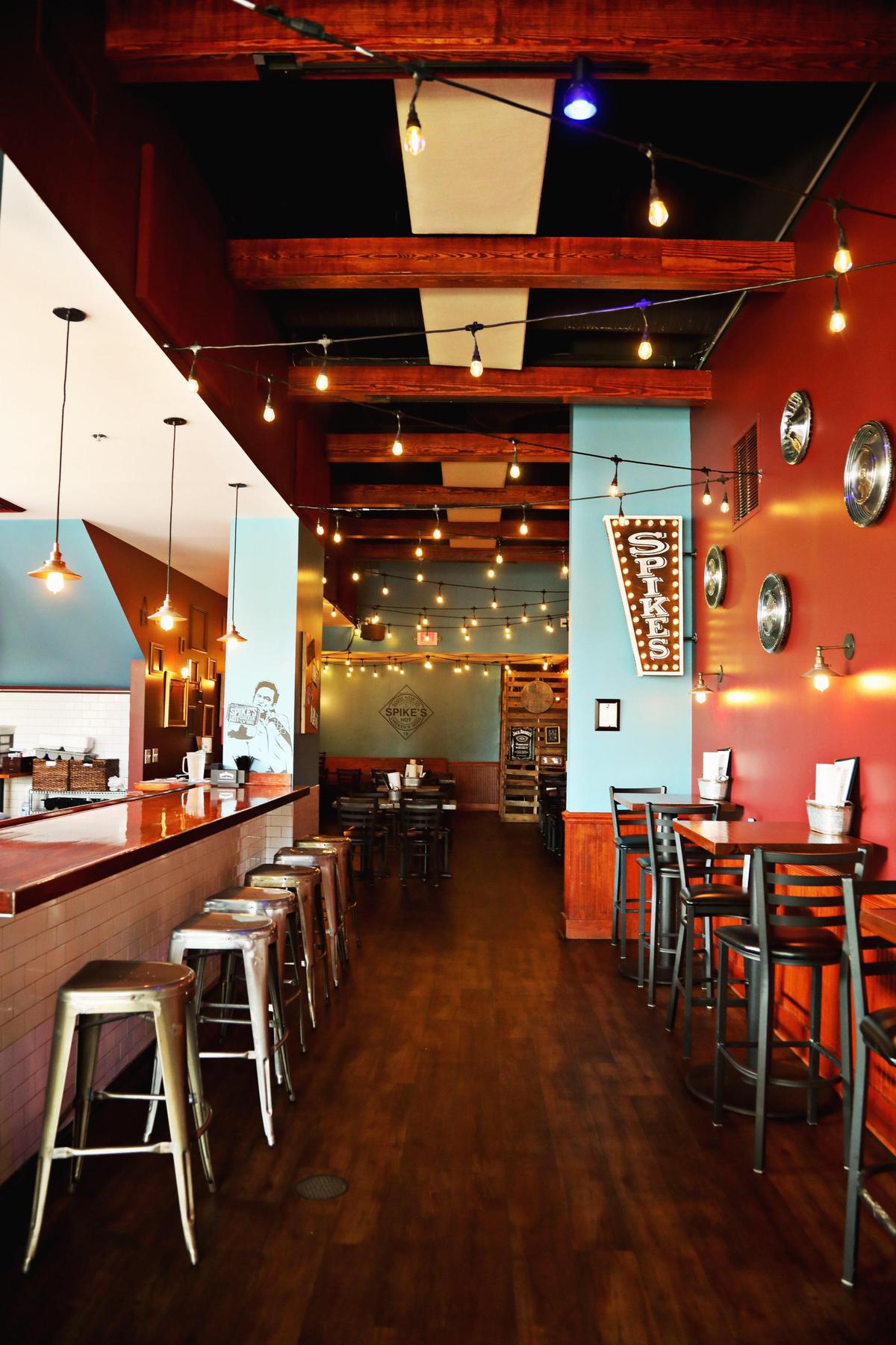 SpikeÕs Hot Chicken & Dogs in Carrboro has a whimsically eclectic vibe, with colorful walls covered in old license plates, empty picture frames and a recurring Elvis motif, including a caricature of the singer and a collection of Cadillac hubcaps.