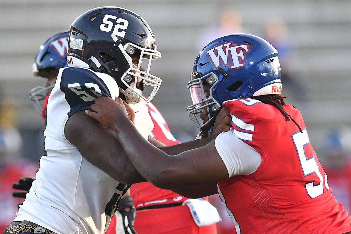 Southeast Raleigh’s Chase Robinson (52) and Wake Forest’s Marcus Smith (53) square-up during a play in the first half of their game.The Southeast Raleigh Bulldogs and the Wake Forest Cougars met in a non-conference game in Wake Forest, N.C. on September 1, 2023.