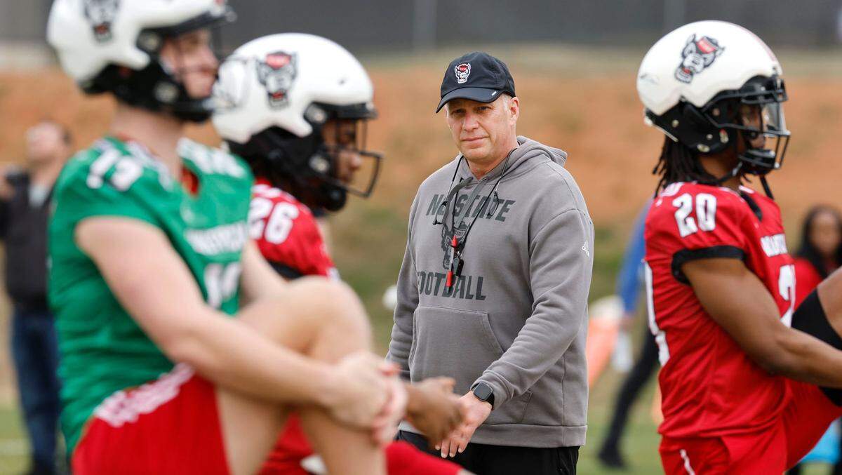N.C. State head coach Dave Doeren watches as players warm up during the Wolfpack’s first spring practice Tuesday, Feb. 27, 2024.