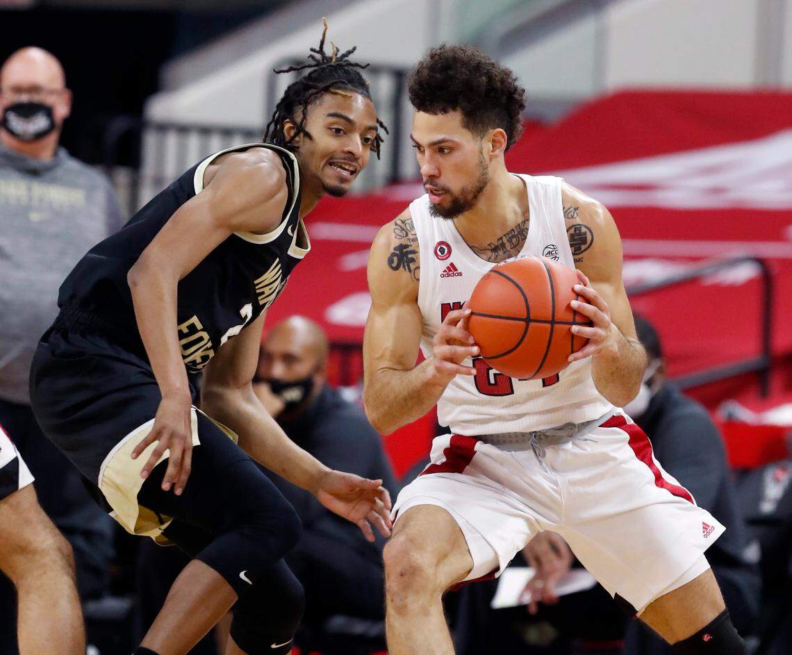 N.C. State’s Devon Daniels (24) drives around Wake Forest’s Jalen Johnson (2) during the first half of N.C. State’s game against Wake Forest at PNC Arena in Raleigh, N.C., Wednesday, January 27, 2021.