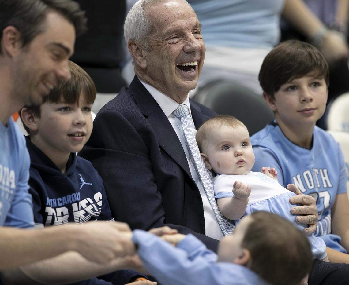 North Carolina coach Roy Williams hold his six-month-old granddaughter Kenzie Newlin as he watches the Tar Heels warm up for their game against Duke on Saturday, February 8, 2020 at the Smith Center in Chapel Hill, N.C.