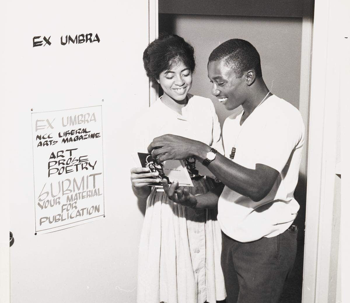 Sandra Page, a North Carolina College senior and prose editor of the college’s literary magazine, “Ex Umbra,” examines a copy of the last issue of the publication with Franklin Williams, a junior staff member, in the doorway of their office in the campus student union building. North Carolina Central University was founded in Durham in 1910.