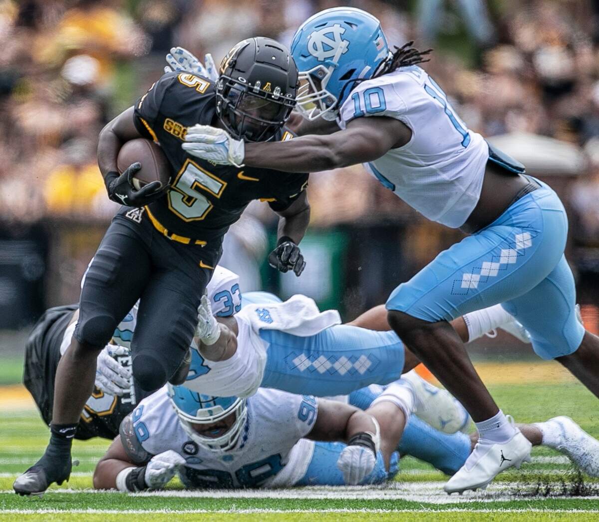 North Carolina’s Desmond Evans (10) stops Appalachian State’s Nate Noel (5) in the second quarter on Saturday, September 3, 2022 at Kidd Brewer Stadium in Boone, N.C