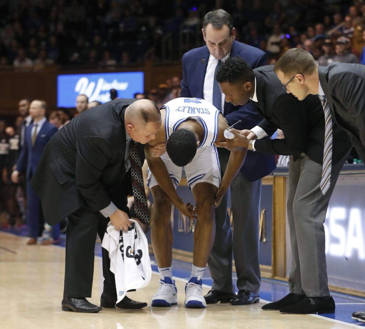 Duke’s Jose Fonseca, Mike Krzyzewski Nolan Smith and Jon Scheyer check on Cassius Stanley after he was injured during the second half of Duke’s 83-70 victory over Winthrop at Cameron Indoor Stadium in Durham, N.C., Friday, November 29, 2019.