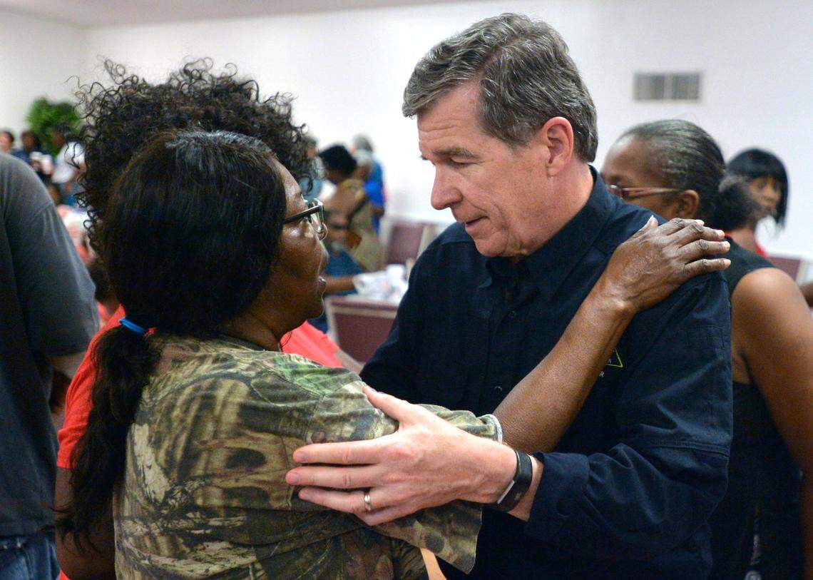 N.C. Governor Roy Cooper talks with Joyce Davis at an event feeding victims of Hurricane Florence at the Bright Hopewell Baptist Church in Laurinburg in Sept. 2018. Cooper was on a tour of agricultural areas hit hard by the storm.