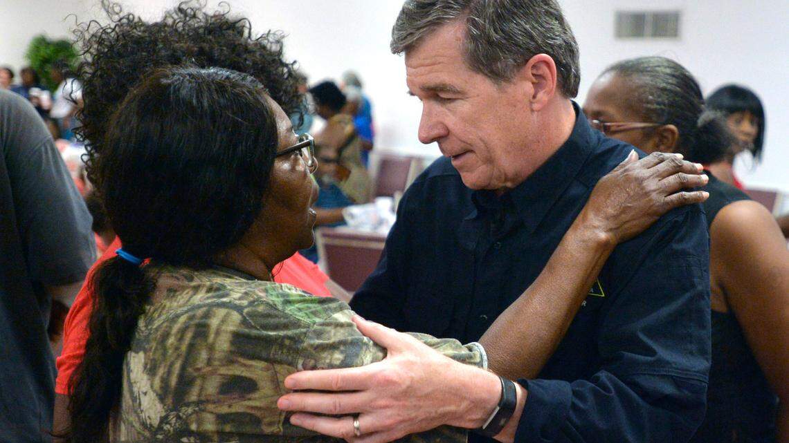 N.C. Gov. Roy Cooper talks with Joyce Davis at an event feeding victims of Hurricane Florence at the Bright Hopewell Baptist Church in Laurinburg in September 2018. Cooper was on a tour of agricultural areas hit hard by the storm.