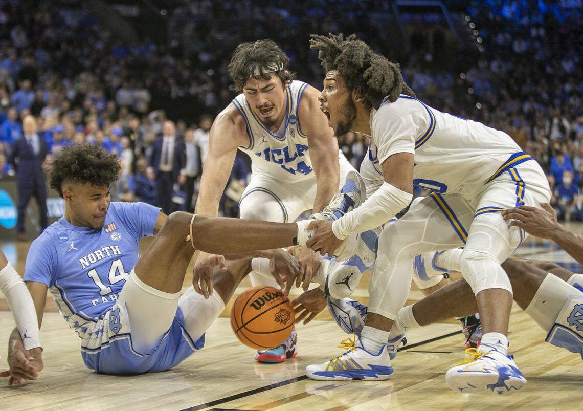 UCLAs Tyger Campbell (10) battles with North Carolinas Puff Johnsons (14) for a loose ball during the second half on Friday, March 25, 2022 during the NCAA East Regional semi-final at Wells Fargo Center in Philadelphia, Pa.