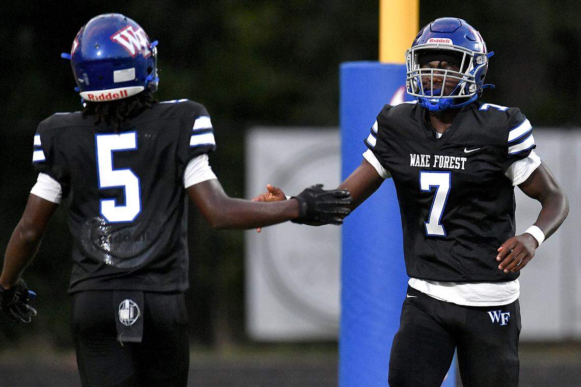 Wake Forest quarterback Kavon Simmons (7) is congratulated by Herbert Pringle (5) after his touchdown against Clayton. The Wake Forest Cougars and the Clayton Comet met in a non-conference football game in Wake Forest, N.C. on August 23, 2024.