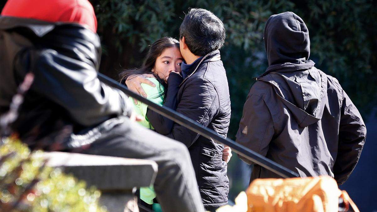 A participant of the dance troupe gets a hug after leaving Hillyer Memorial Christian Church in Raleigh, N.C., Saturday, Nov. 19, 2022. A truck pulling a float went out of control at the Raleigh Christmas Parade injuring at least one person.