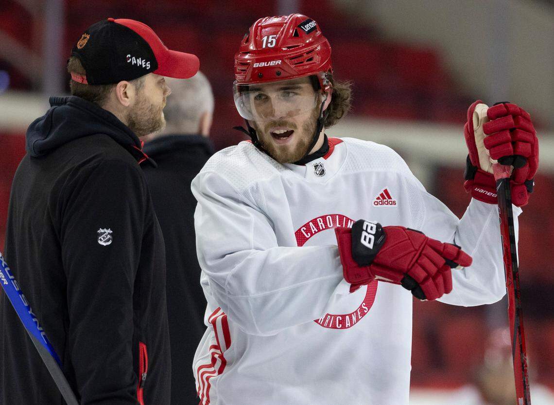 Carolina Hurricanes defenseman Dylan Coghlan (15) talks with assistant coach Tim Gleason during practice on Thursday, May 2, 2024 at PNC Arena in Raleigh, N.C. Coghlan wears a high-tech Kevlar undershirt with a collar to protect his neck from a possible skate cut.